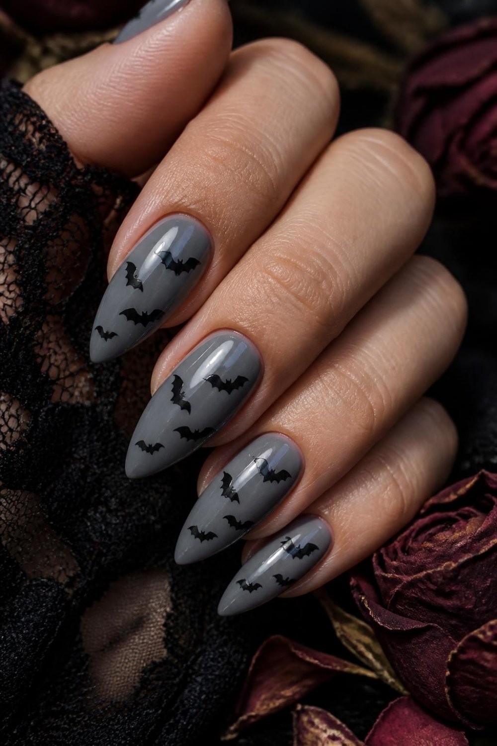 Black bat gothic nails with small bat silhouettes on grey almond nails