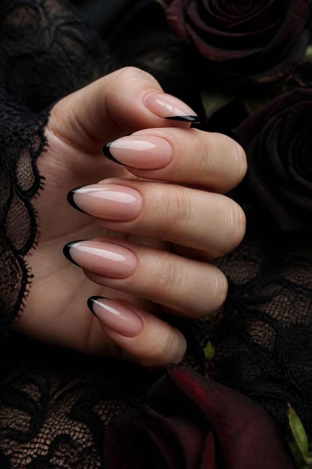 Black French tip gothic nails on sheer nude almond nails