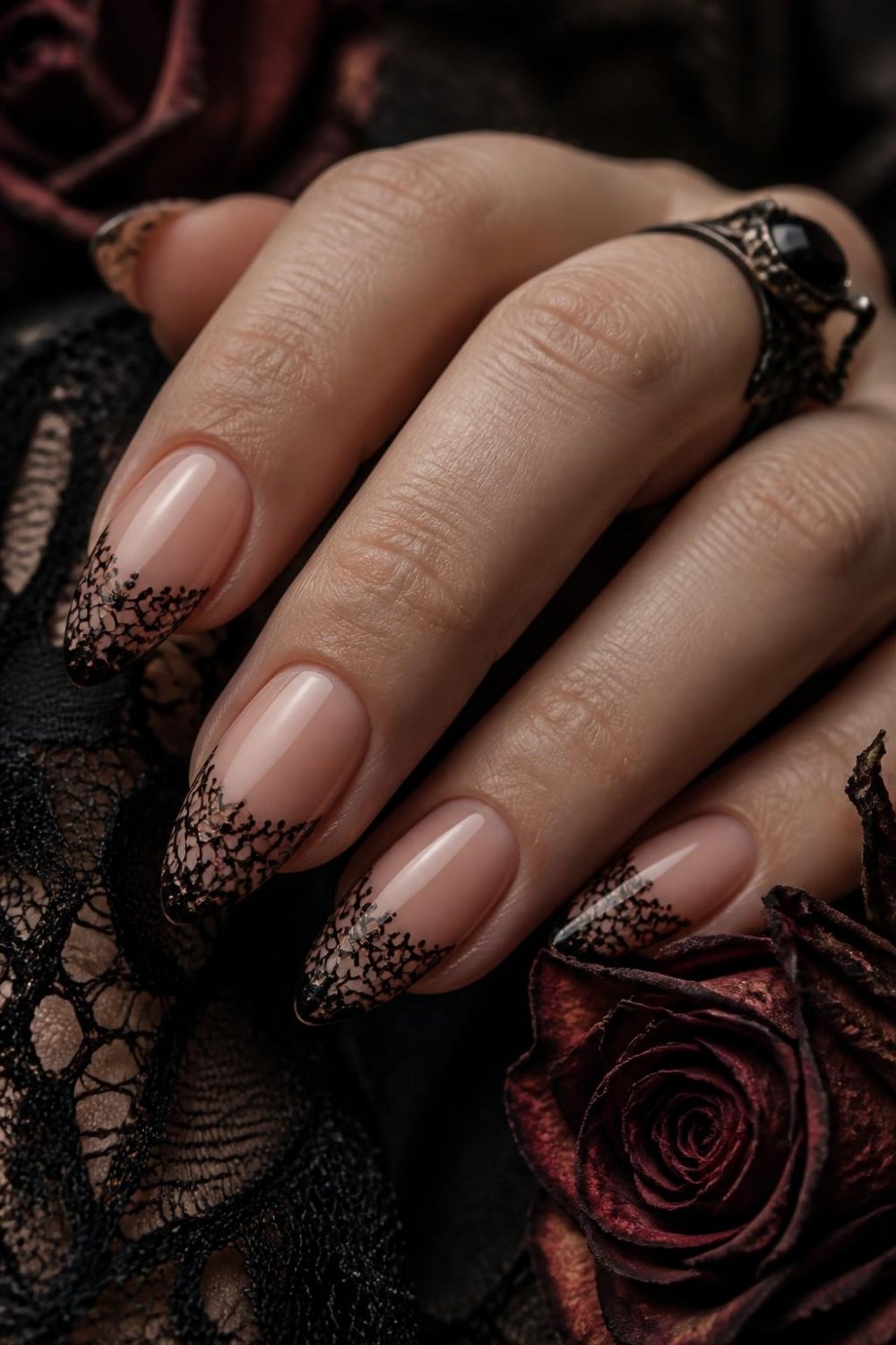 Black lace gothic nails with delicate lace pattern on nude almond nails