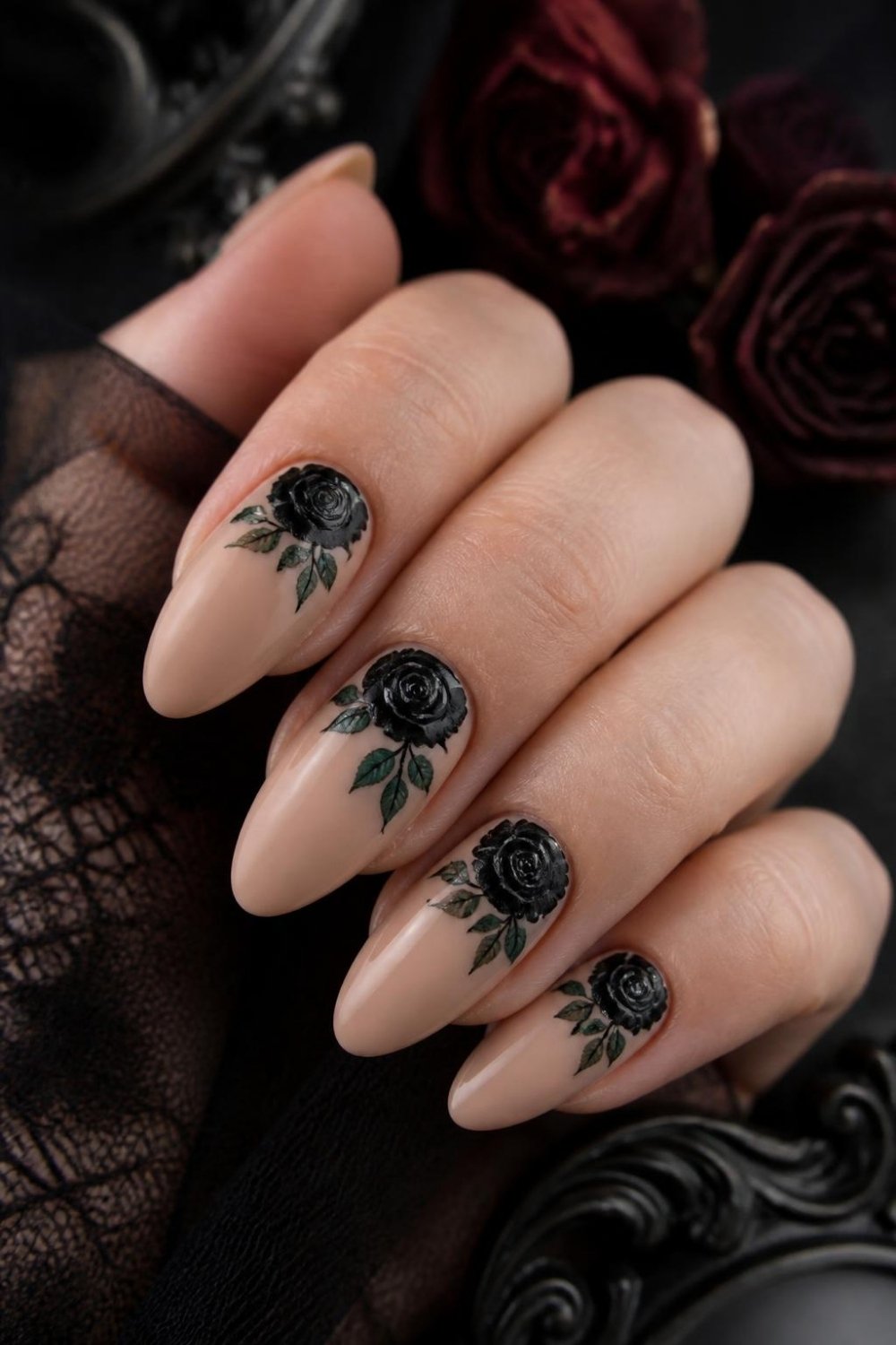 Black rose gothic nails with painted black roses on nude almond nails