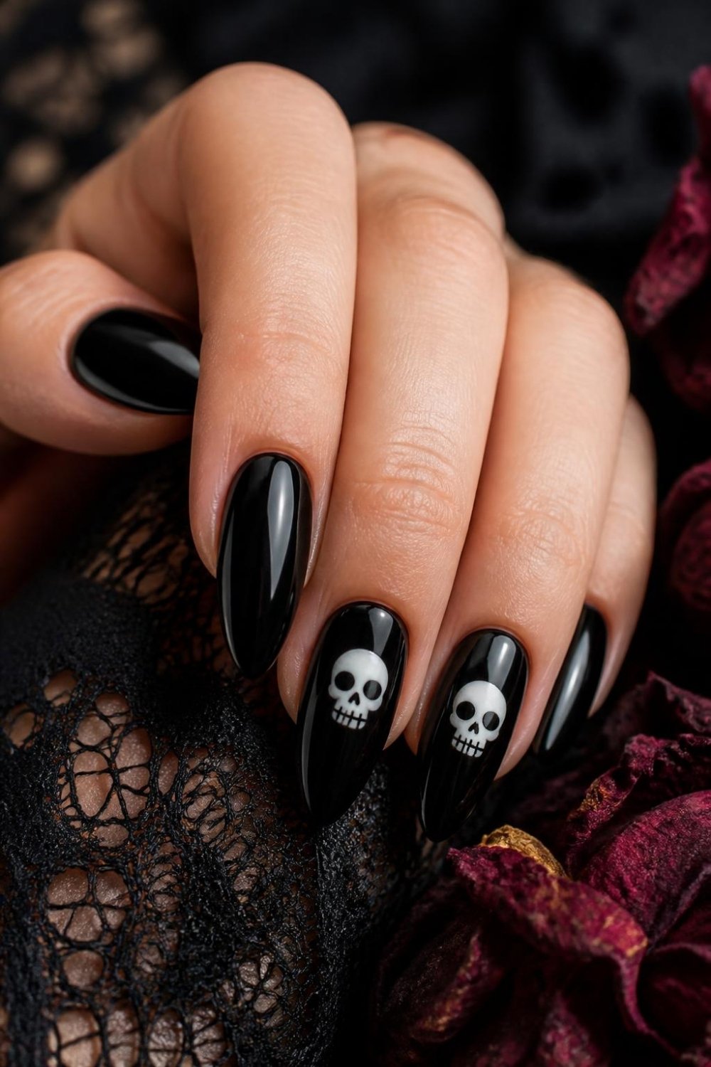 Black skull gothic nails with small white skulls on black almond nails