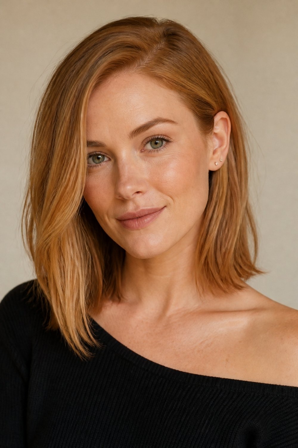 Tucked behind ear lob haircut in strawberry blonde long bob